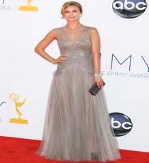 Emily VanCamp took sweet Revenge on the red carpet in a demure J. Mendel chiffon dress with a daring neckline to flaunt some flirty décolletage. Her metallic-croc Judith Leiber clutch juxtaposed with a diamond bow-tie bracelet played up the same sort of polar-opposite panache. We somehow feel that Emily Thorne would be proud of the "girl-next-door with ulterior motives" vibe it projected. Photo: Matt Baron/BEImages emmys-dresses-emily-vancamp