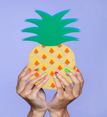 Neon Smörgåsbord
There's a little of this, a little of that, and all of it in eye-searing neon — so much to love. For this look, Handa mixed and matched colors and designs, doing a half-moon here, a reverse French tip there, a 50/50 split over there. The key is to separate the nail art with a non-designed nail, and to make sure you don't have two of the same color on adjacent nails.
It's important to pick complementary hues, like mixing pink and green, or orange and yellow. Also imperative? Making sure you add a topcoat: "Neon polishes tend to dry quickly and lose their vibrancy," says Handa. "This can make them look dull, so in order to keep them shiny, you must use a topcoat over them." 01_Nailapalooza_060713_037_1_r