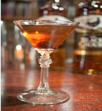 A Quiet Smoke in the Woods
Created by Mike Ryan, Sable Kitchen & Bar.
2 oz. The Black Grouse
.75 oz. Madeira
.25 oz Luxardo Maraschino Liqueur
Two hard dashes Angostura bitters
Stir and strain, serve up in a coupe glass. Garnish with a Luxardo cherry.
Photo: Courtesy of M Booth
final-a quiet smoke in the woods