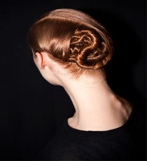 We'd say it might be time for braids to take a back seat, because apparently twists are officially the new kids on the block, as seen backstage at Honor. While this look (created by James Pecis for Bumble and bumble) may appear super-intricate, it's really just made up of a bunch of tight twists, pinned into a chignon shape. "Party in the back," much?
Photo: Courtesy of Bumble and bumble honor-photoshop