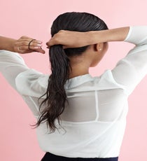 Gather hair into a ponytail at the nape of the neck and secure with an elastic. LowBun_044_R
