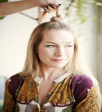 Step 2: Twist the hair and tie into a top knot. Secure with a single bobby pin, leaving the end of the hair out. For super-thick hair, you may need an extra pin or two. style2_step2