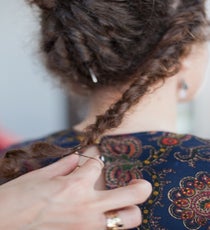 Step 3: French braid the hair at the nape of the neck and around the head, forming a braided headband.
Advanced Tip: For added depth, inside-out French braid the hair instead. 31_17_style2_step6-