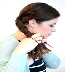 Begin braiding your ponytail into a traditional three-strand braid. Secure with a hair elastic, then repeat with the remaining section. braided-hairstyle-4