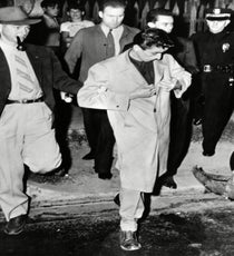 Zoot Suit Riots Make An Oversized Statement
Though it's the only men's trend on this list, the racial and class implications of the Zoot Suit Riots shouldn't be overlooked. In the midst of World War II, young Mexican Americans in the Los Angeles area were targeted by military servicemen who determined that the Zoot suit was unpatriotic. As Dincuff explains, "The Zoot suit used a lot of fabric, which was expensive during wartime, and is a super exaggerated fit. Sometimes the jacket goes down to the knee, which was a sign of wealth — and a lack of patriotism — when rationing was such a serious issue."
By wearing the suit, poor Mexican men were able to flout authority and send a message to a government they didn't feel invested in them. As Eleanor Roosevelt wrote, "The question goes deeper than just suits. It is a racial protest. I have been worried for a long time about the Mexican racial situation. It is a problem with roots going a long way back, and we do not always face these problems as we should."
Photo: Rex USA zoot-suit